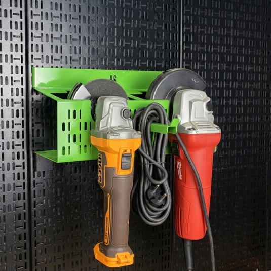 Wall-mounted tool organizer holding two angle grinders against a black patterned wall.