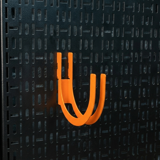 Orange steel U-shaped tool on a textured black background