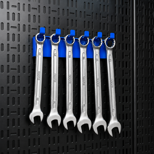 Set of wrenches on a blue hook against a black pegboard background