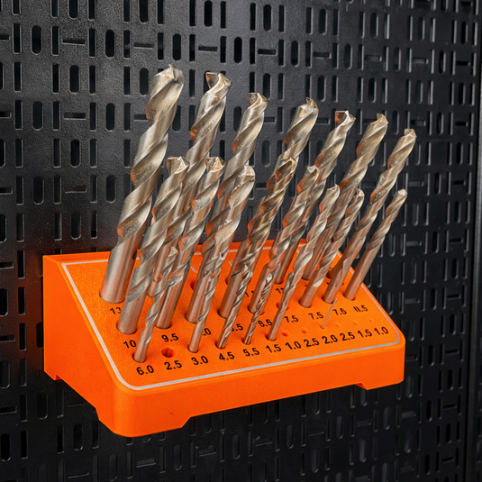 Set of drill bits on an orange holder against a black textured background