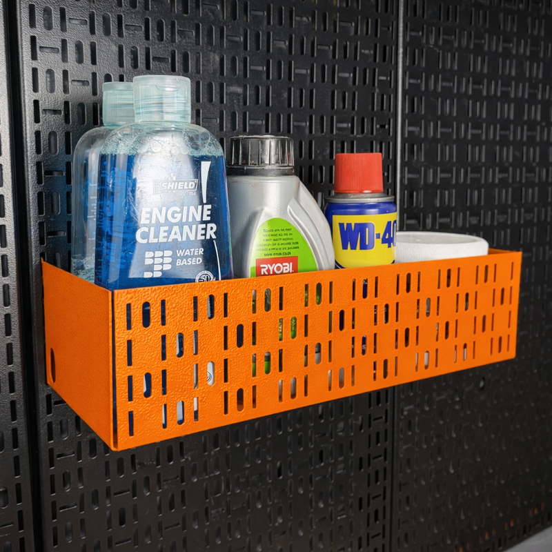 Load image into Gallery viewer, Orange storage basket with cleaning supplies on a black pegboard wall

