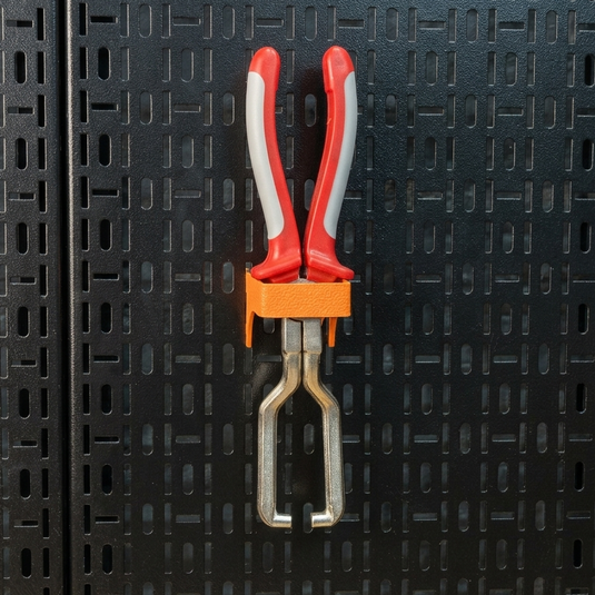 Red and gray pliers with an orange handle on a black textured background
