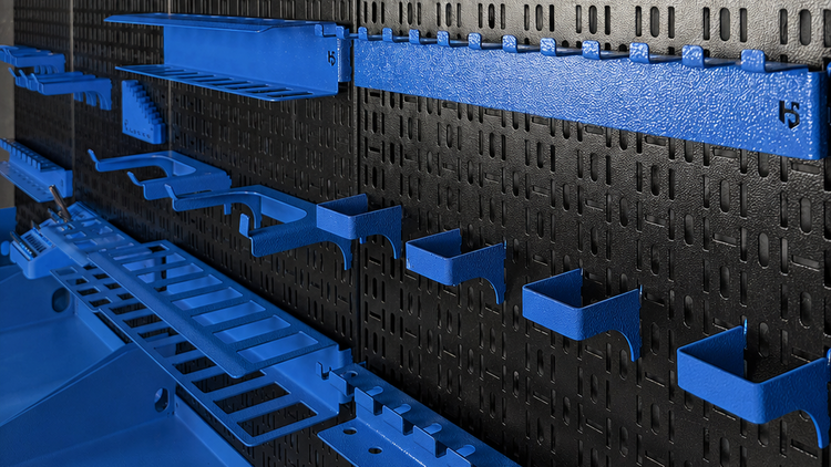 Storage system with blue shelves and black pegboard wall
