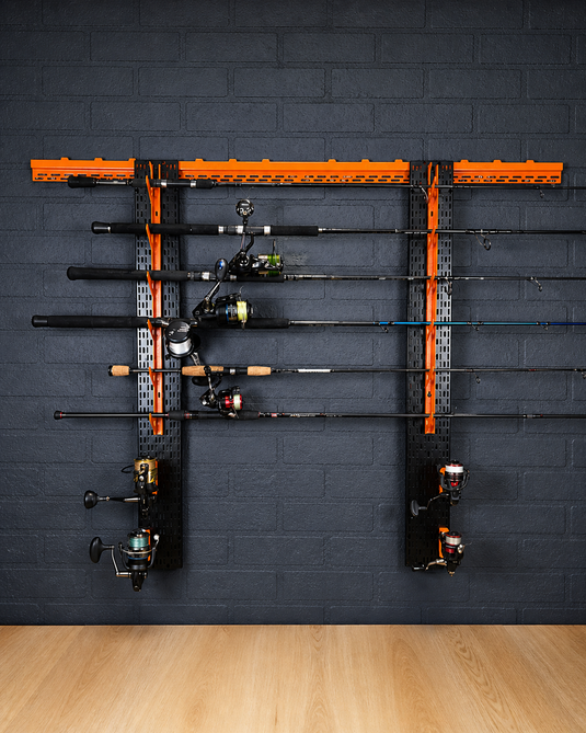 Fishing rod holder with multiple fishing rods against a dark brick wall.