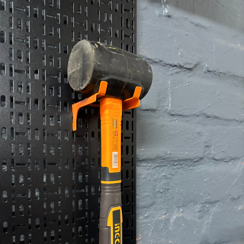 Load image into Gallery viewer, Hammer with black handle and orange head on a textured black surface
