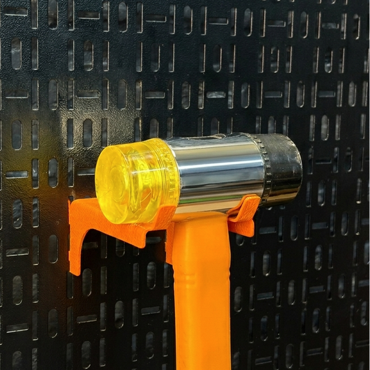 Handheld tool with yellow and orange handle on a black textured background