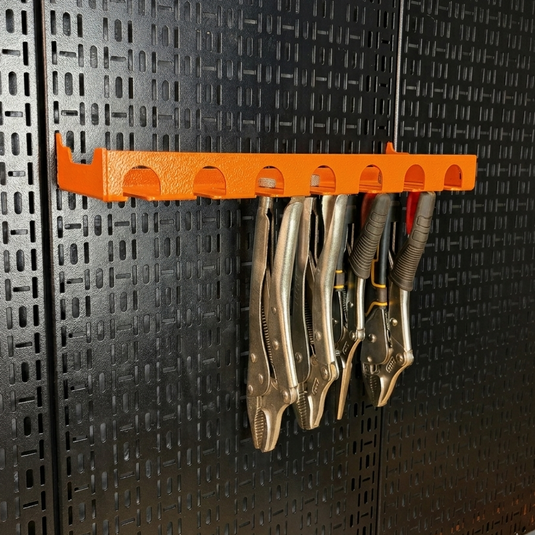 Orange tool holder with vice grips on a black pegboard